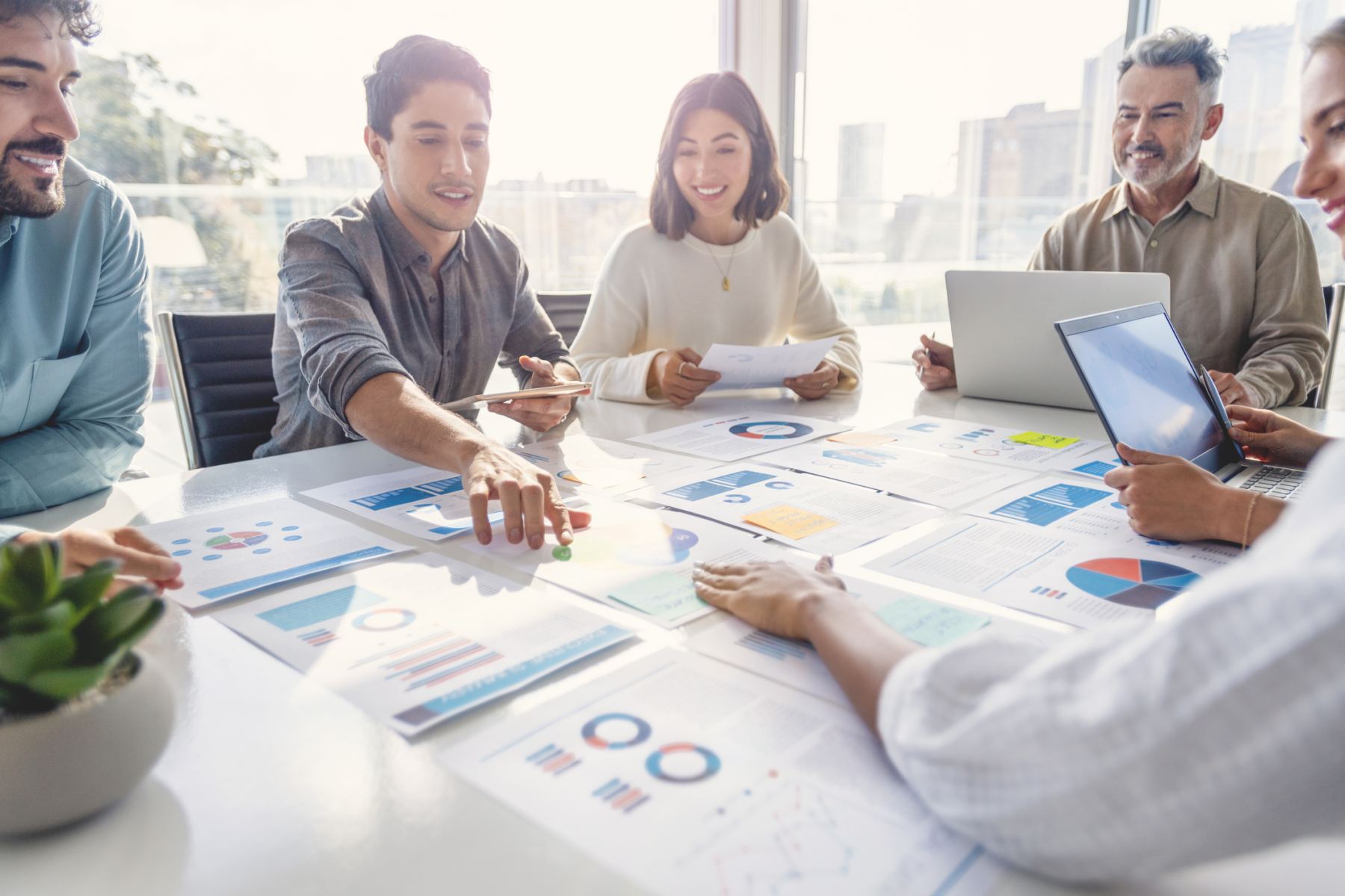 Successful young business woman freelancer manager accountant counting funds, savings, money using calculator in office. Woman paying domestic bills, economizing. Economy and finances concept